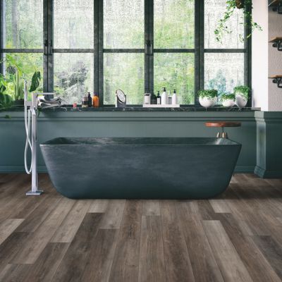 luxury vinyl plank floors in a Montana bathroom with green tub